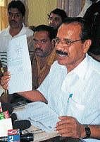 M P D V Sadananda Gowda exhibiting the documents                   pertaining to railway works, in a news conference at Chikmagalur on Thursday. DH Photo