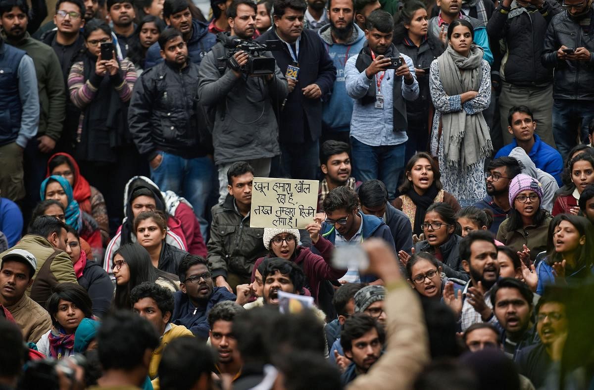 Students stage a protest at main Gate of JNU over Sunday's violence, in New Delhi, Monday, Jan. 6, 2020. Violence broke out at Jawaharlal Nehru University on Sunday night as masked men armed with sticks attacked students and teachers and damaged property on the campus, prompting the administration to call in police. PTI