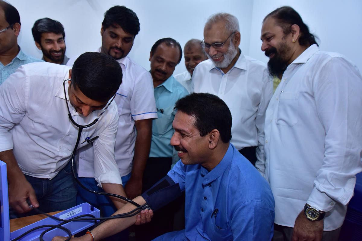Dakshina Kannada MP Nalin Kumar Kateel gets his blood pressure checked during the inauguration of the free emergency medical service centre set up by Unity Hospital at Mangaluru Central Railway station on Sunday.