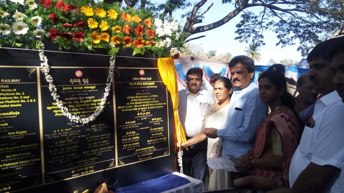 MP Shobha Karandlaje unveils a plaque after laying the foundation for development works at Tarikere Railway Station.