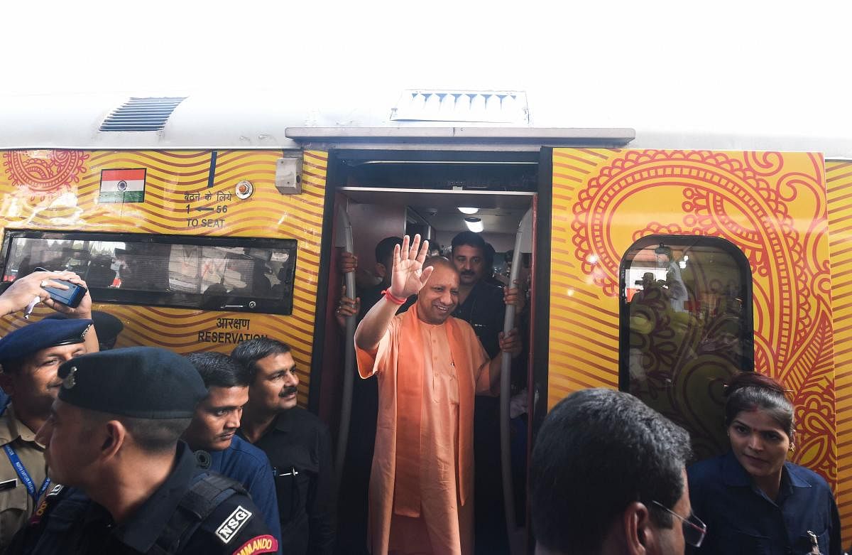 Uttar Pradesh Chief Minister Yogi Adityanath waves after visiting the Lucknow-Delhi Tejas Express, India's first 'private' train by IRCTC, during its flag-off ceremony at the Charbagh Railway station. PTI