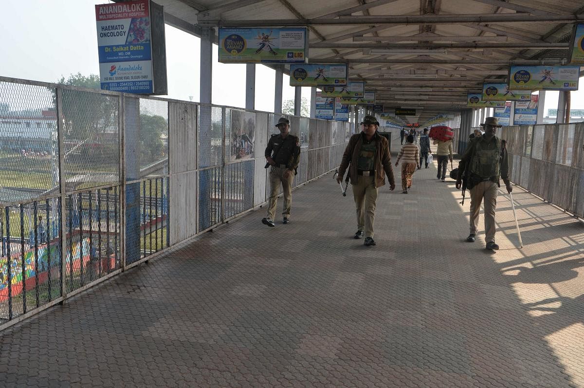 Members of the railway special protection force (RPSF) patrol on a quiet pedestrian bridge at New Jalpaiguri Railway station after several trains were cancelled due to protests against India's new citizenship law in Siliguri on December 17, 2019. (AFP Pho