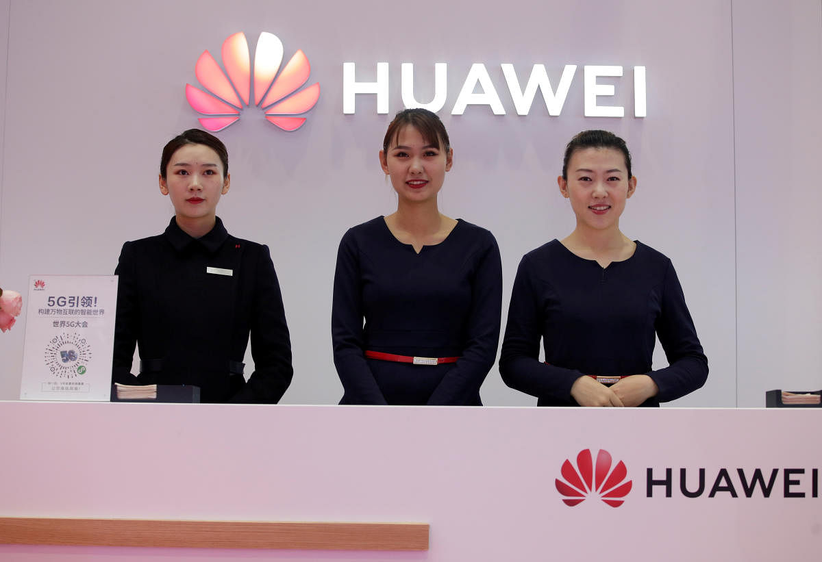 Attendants stand at a Huawei booth at the World 5G Exhibition in Beijing, China. (REUTERS photo)