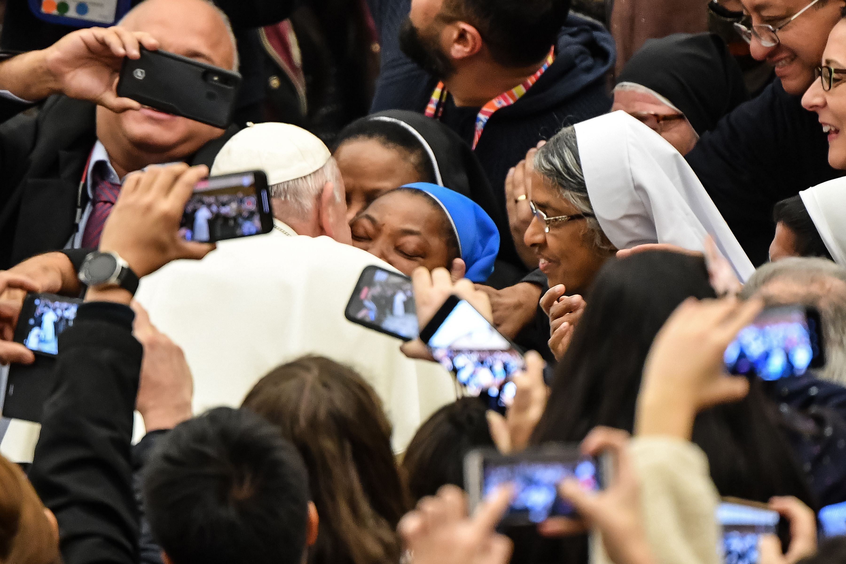 Pope Francis kisses a nun who had been shouting "Long live the pope!" as he arrives for the weekly general audience on January 8, 2020 at Paul-VI hall in the Vatican. (AFP Photo)