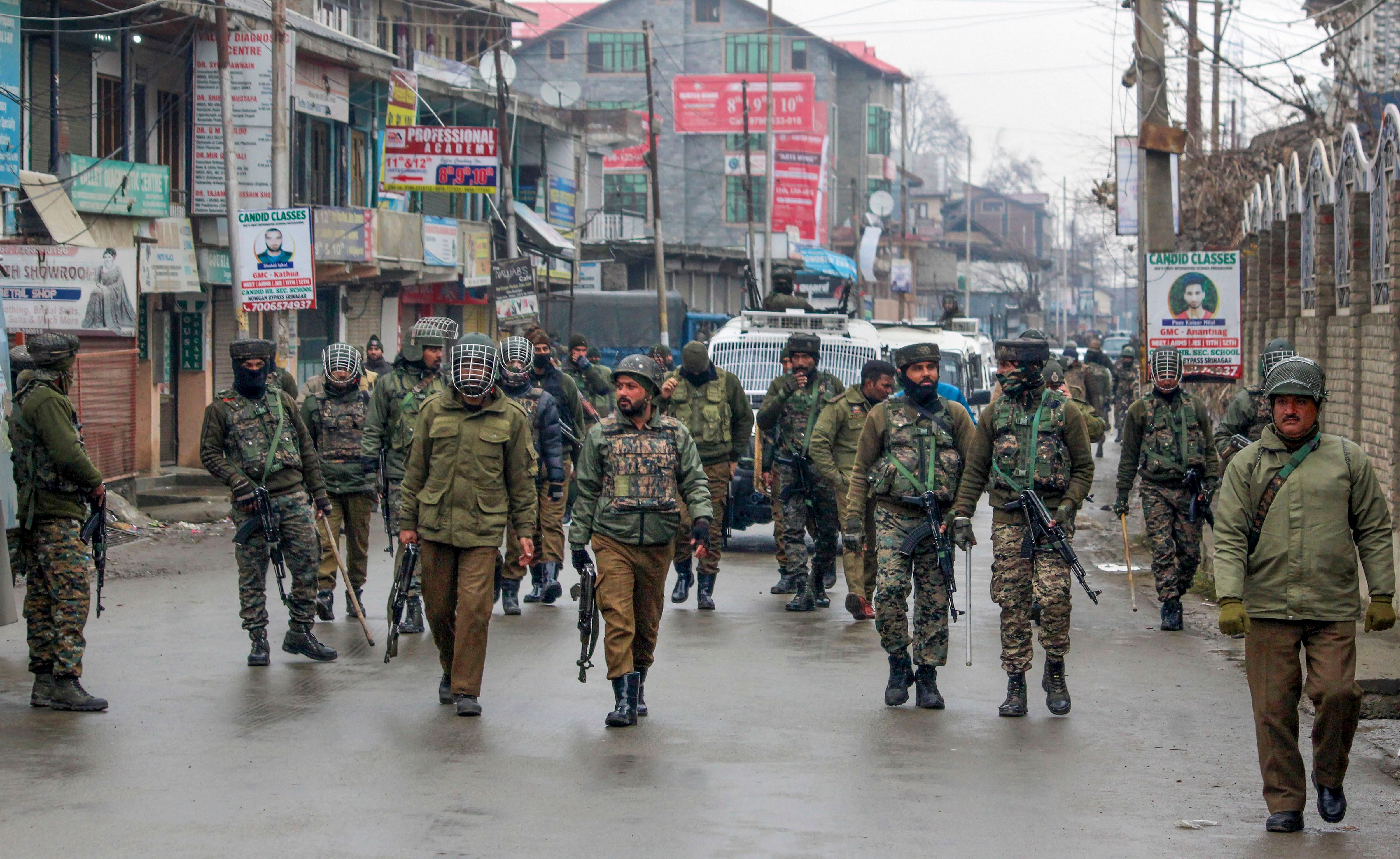ecurity personnel patrol a street after clashes which erupted after a police vehicle collided with a car in an accident killing a 10th class student Tehseen Ahmed Bhat, at Nowgam in Srinagar. (PTI Photo)