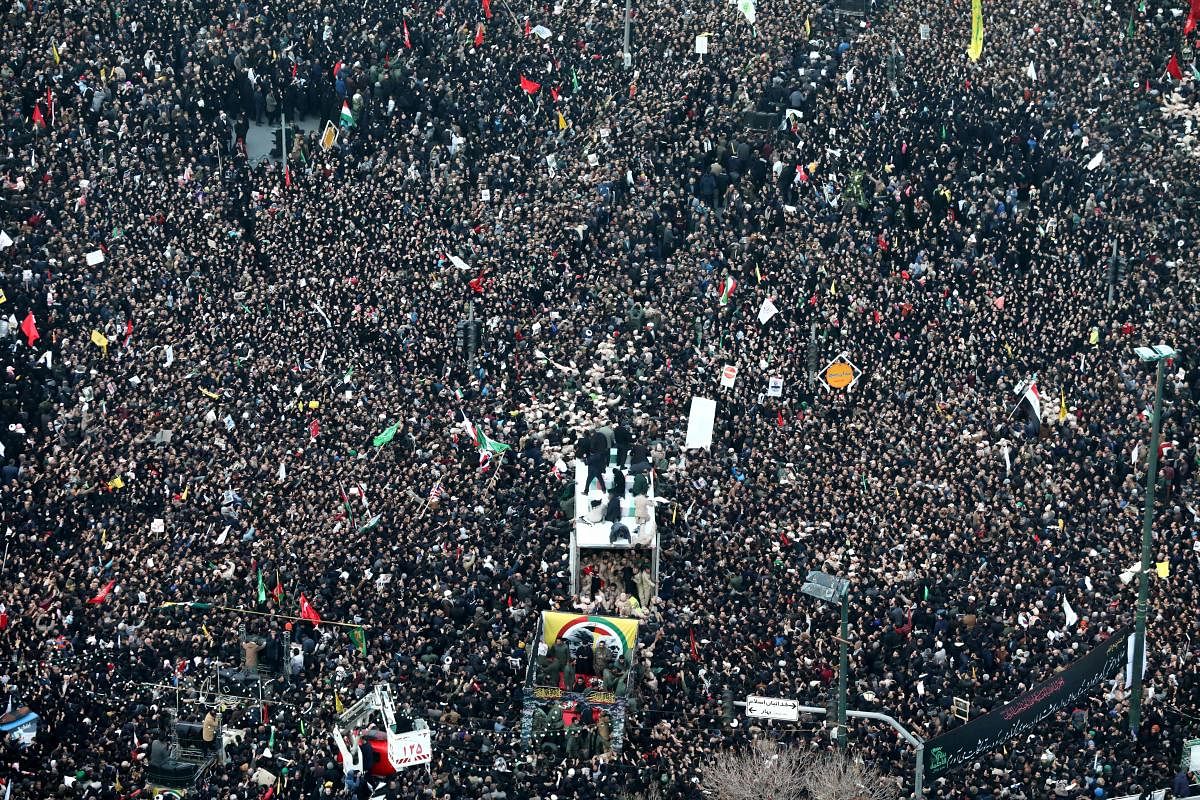 Iranians gather around a vehicle carrying the coffins of slain major general Qassem Soleimani and others as they pay homage in the northeastern city of Mashhad on January 5, 2020. (Photo by AFP)