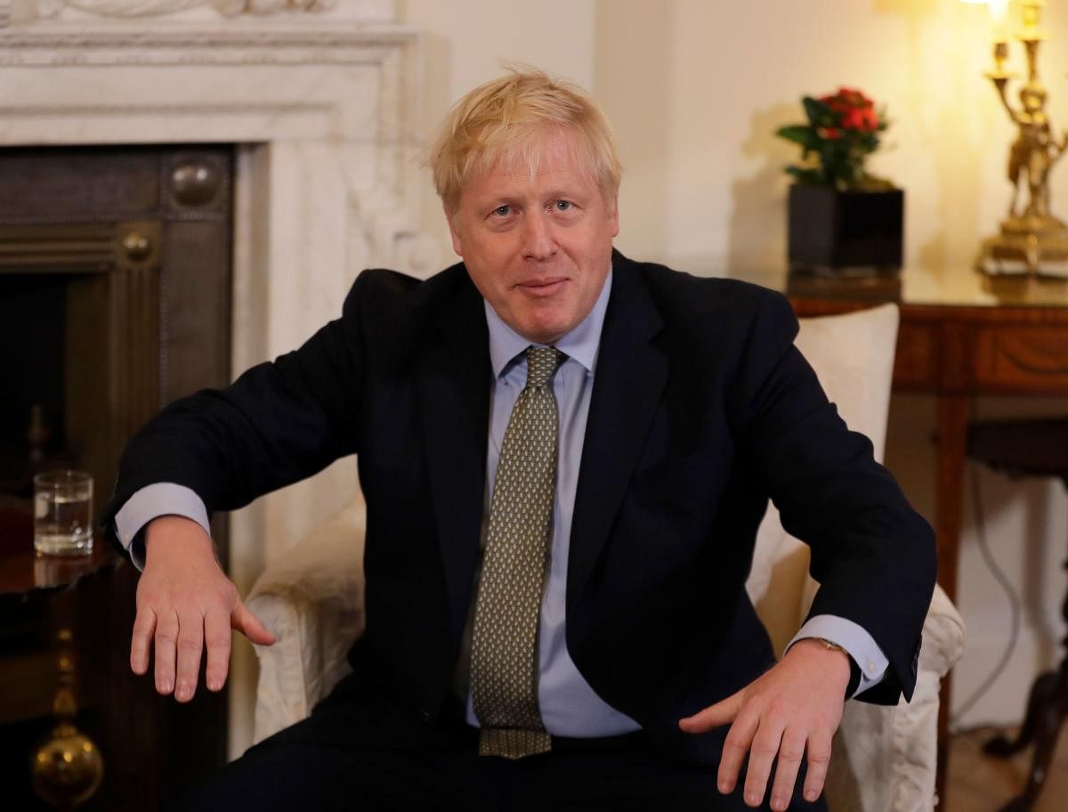 Britain's Prime Minister Boris Johnson gestures as he interacts with European Commission President Ursula von der Leyen inside 10 Downing Street in central London on January 8, 2020, ahead of their meeting. (AFP Photo)