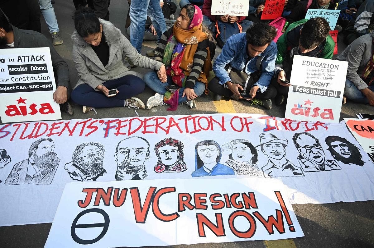 Protesters sit next to placards and banners at a demonstration against India’s new citizenship law and against an attack on the students and teachers at Jawaharlal Nehru University (JNU) campus, in New Delhi in January 9, 2020. (Photo by Money SHARMA / AFP)