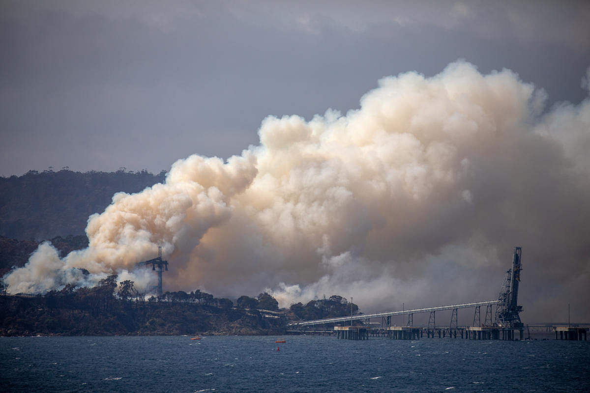 Smoke rises from the Eden Woodchip Mill, from a fire that has been blazing for days, in Eden. Reuters
