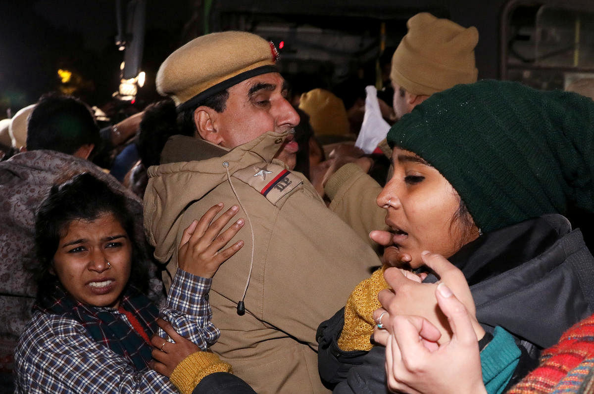 Protesters scuffle with police officers as they detain demonstrators during a protest march against the attacks on the students of Jawaharlal Nehru University (JNU), in New Delhi. (Credit: Reuters)