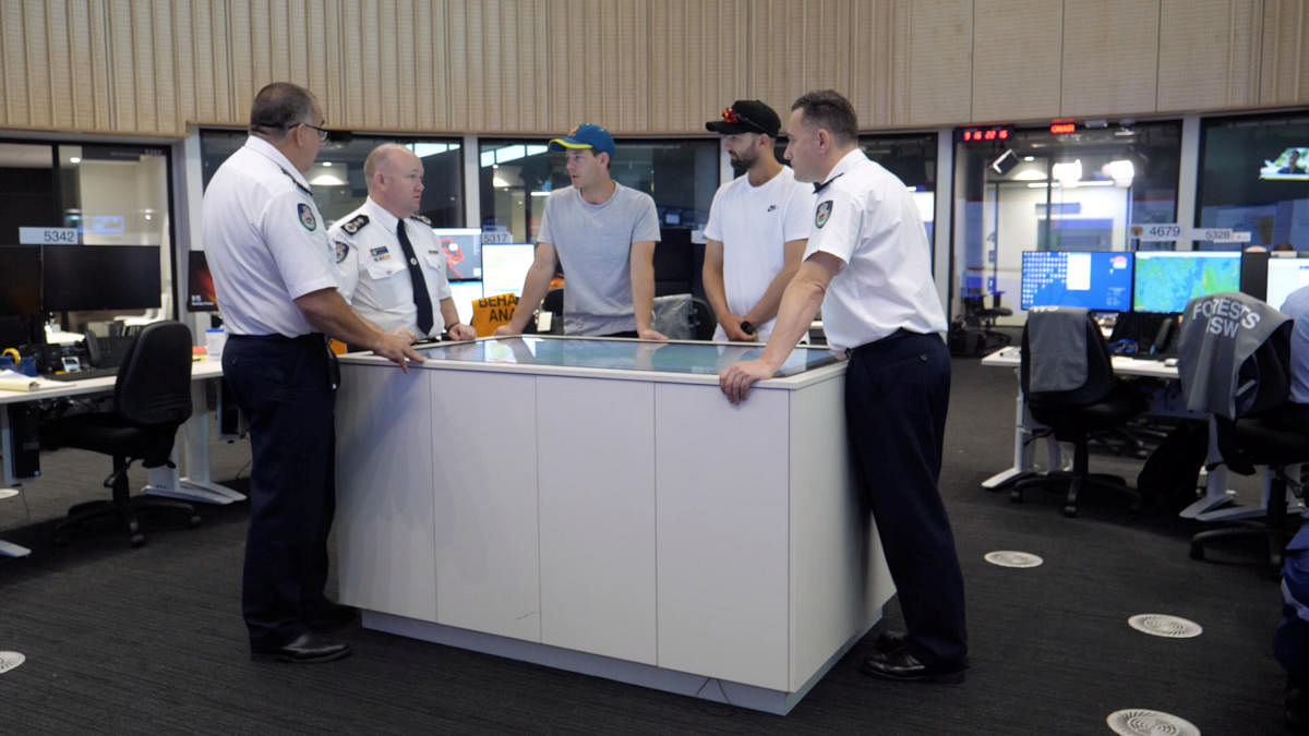 Australia cricketers Tim Paine and Nathan Lyon visit Fire Department Control Centre in Southern Highlands. Photo:Reuters/Cricket Australia
