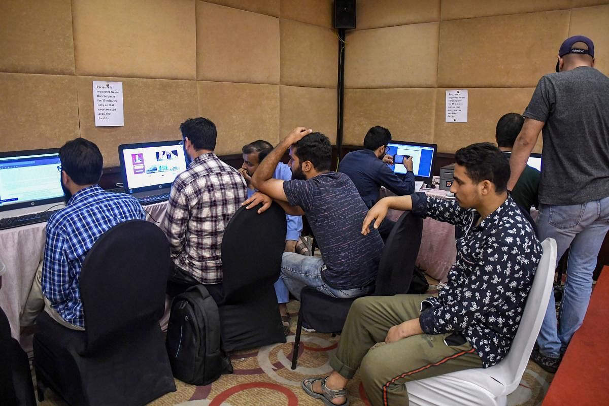 Journalists wait for their turn to access the internet at a temporary media centre set up by the government, on the 42nd day following the abrogation of Article 370, in Srinagar, Sunday, Sept. 15, 2019. Internet services remained suspended across all platforms, while landline across the valley were functional, voice calls on mobile devices were working only in Kupwara and Handwara police districts of north Kashmir. (PTI Photo)