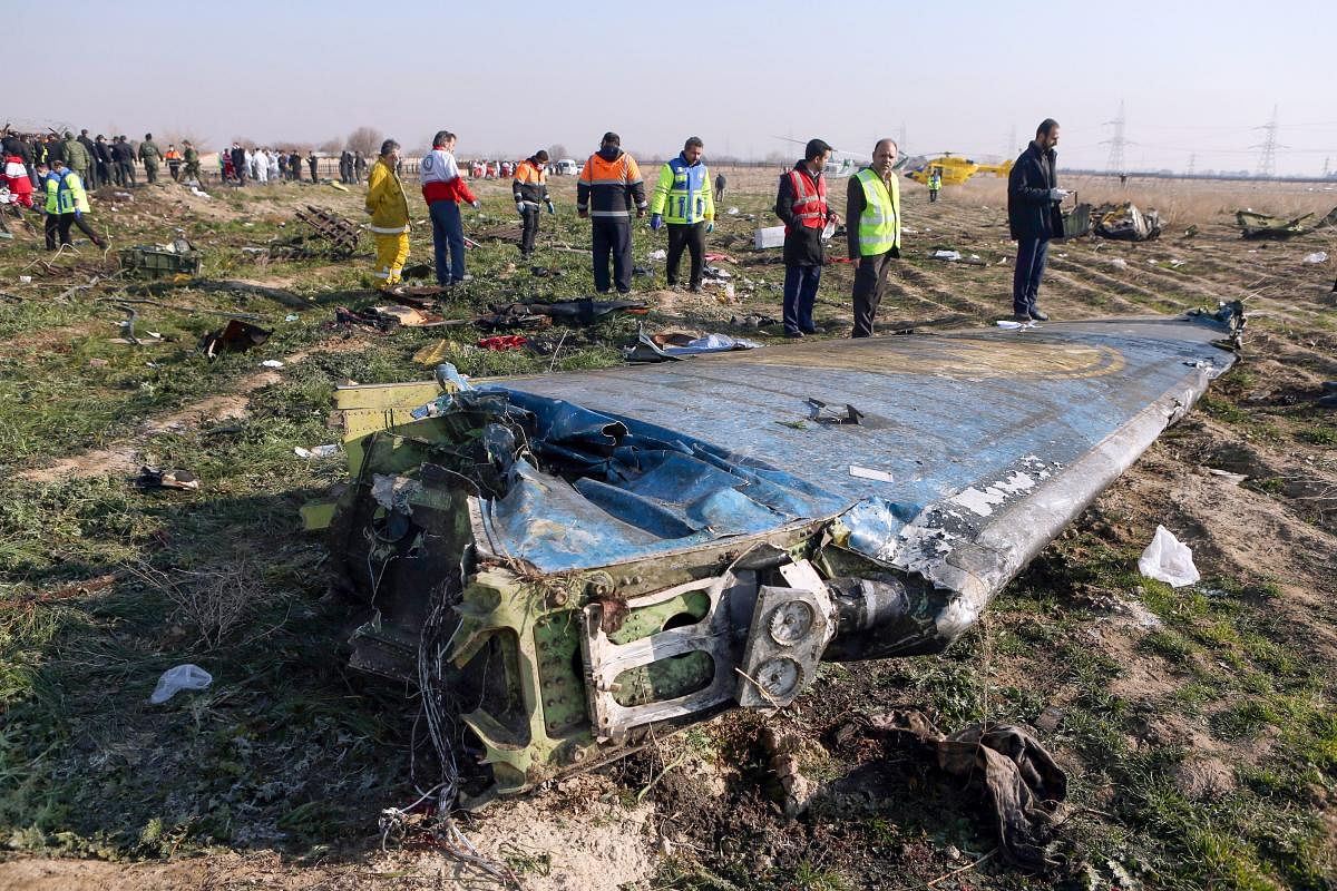 In this file handout photo provided by the Iranian news agency IRNA on January 8, 2020, rescue teams work at the scene of a Ukrainian airliner that crashed shortly after take-off near Imam Khomeini airport in the Iranian capital Tehran. (AFP Photo)