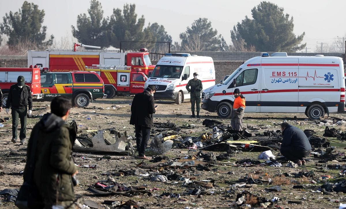 In this file photo taken on January 08, 2020, rescue teams work amidst debris after a Ukrainian plane carrying 176 passengers crashed near Imam Khomeini airport in the Iranian capital Tehran. (AFP Photo)