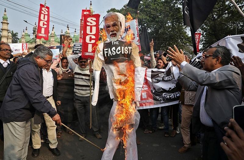 Activists of Socialist Unity Centre of India (SUCI) burn an effigy depicting India's Prime Minister Narendra Modi during a protest against his visit to the state and against a new citizenship law, in Kolkata. (Reuters Photo)