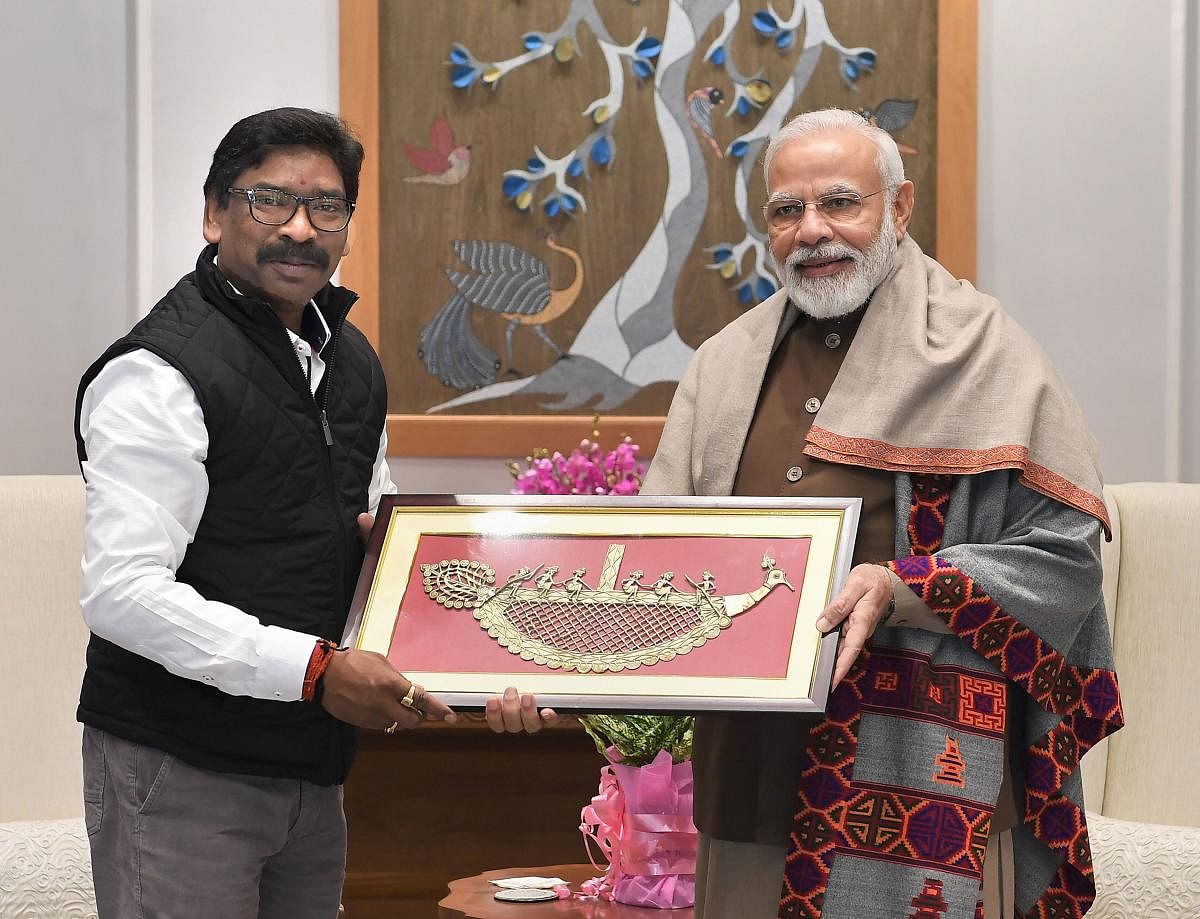  Prime Minister Narendra Modi recieves a memento from Jharkhand Chief Minister Hemant Soren during a meeting in New Delhi. (PTI Photo)