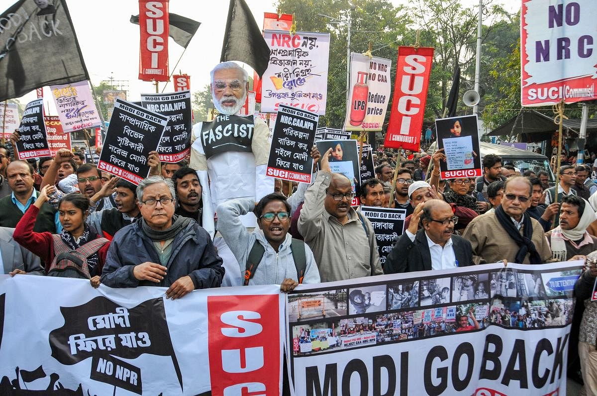 SUCI activists participate in a protest against arrival of PM Narendra Modi to the city over CAA, NRC and NPR and violence in JNU, in Kolkata. (Credit: PTI)