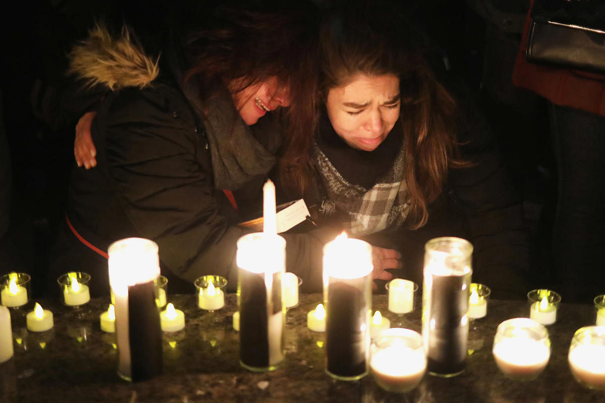 Mourners attend an outdoor vigil for the victims of a Ukrainian passenger jet which crashed in Iran, in Toronto, Canada. Iran admitted to unintentionally shooting down the jet. (REUTERS Photo)
