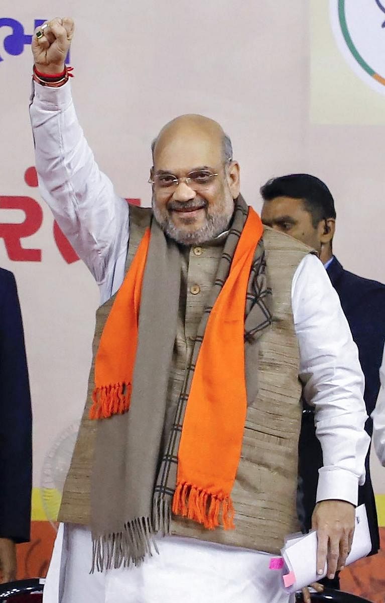 Union Home Minister Amit Shah raises his fist at a function in Ahmedabad, Saturday, Jan 11, 2020. (PTI Photo)