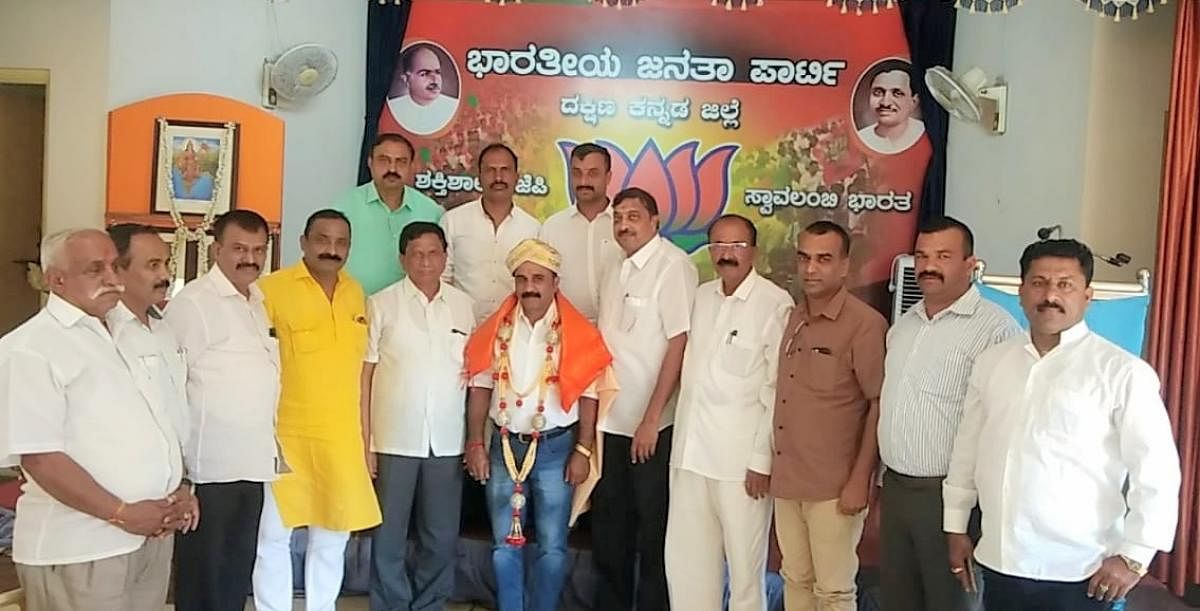 Paleyanda Robin Devaiah being felicitated by BJP leaders, after he was appointed the president of Kodagu district BJP, at Dakshina Kannada district BJP office in Mangaluru, on Sunday. DH Photo