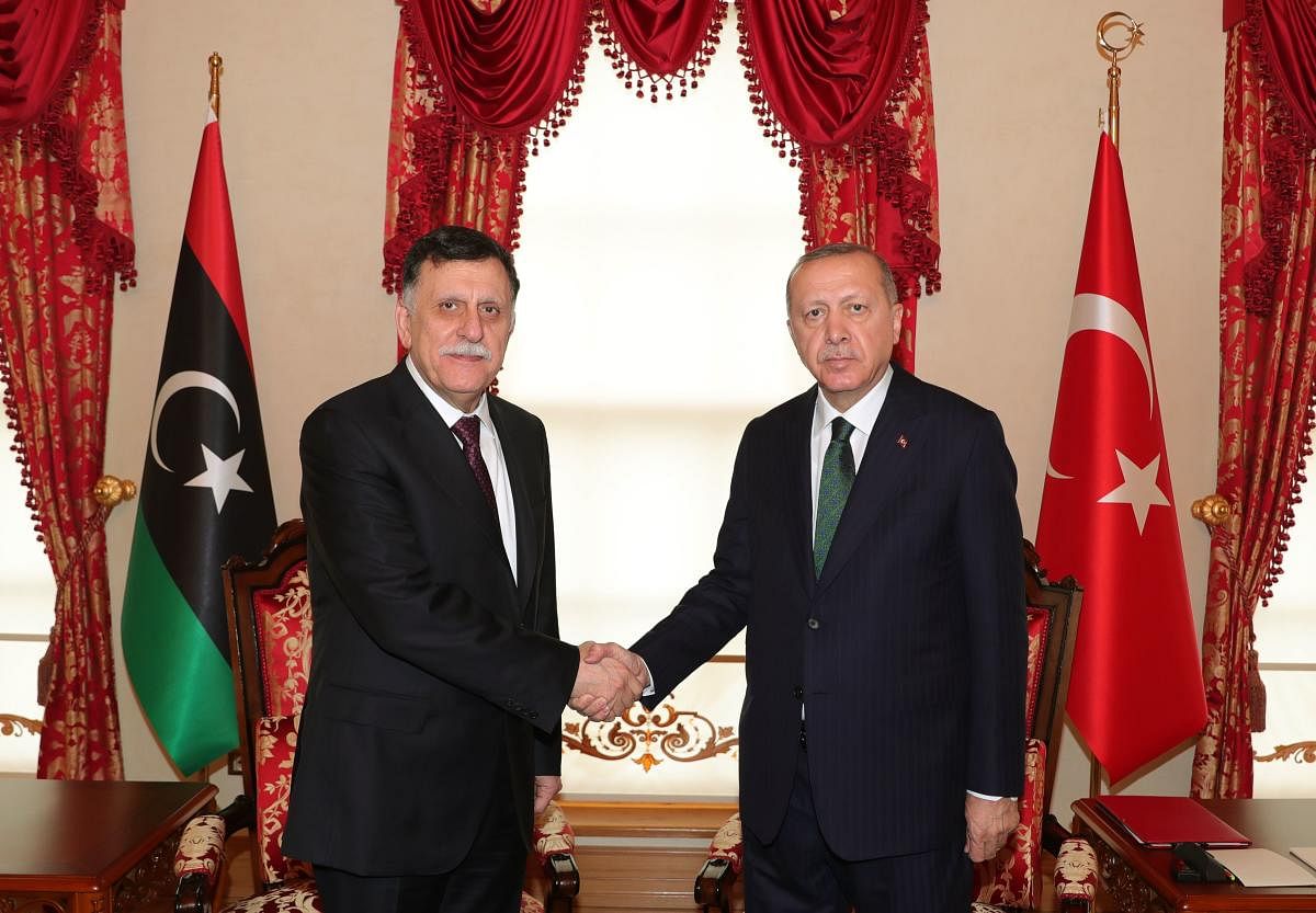 Turkey President Recep Tayyip Erdogan (R) shakes hand with the head of Libya's Government of National Accord (GNA) Fayez al-Sarraj (L) at the start of their meeting in Istanbul. Photo Reuters