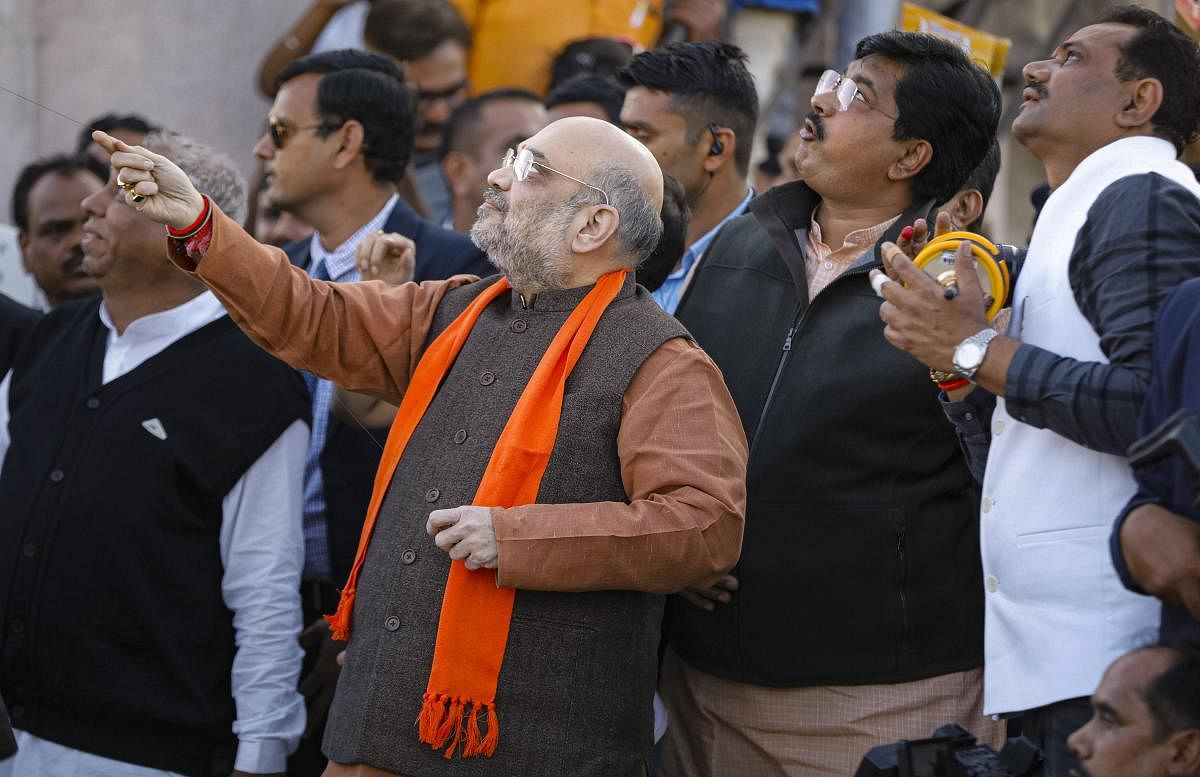  Union Home Minister Amit Shah flies a kite during the kite flying festival 'Uttarayan', in Ahmedabad. (Credit: PTI)