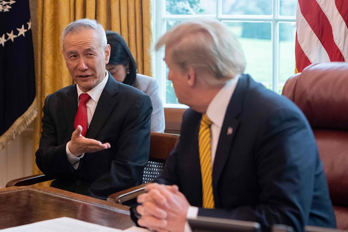 China's Vice Premier Liu He (L) speaks with US President Donald Trump during a trade meeting in the Oval Office at the White House. (AFP Photo)