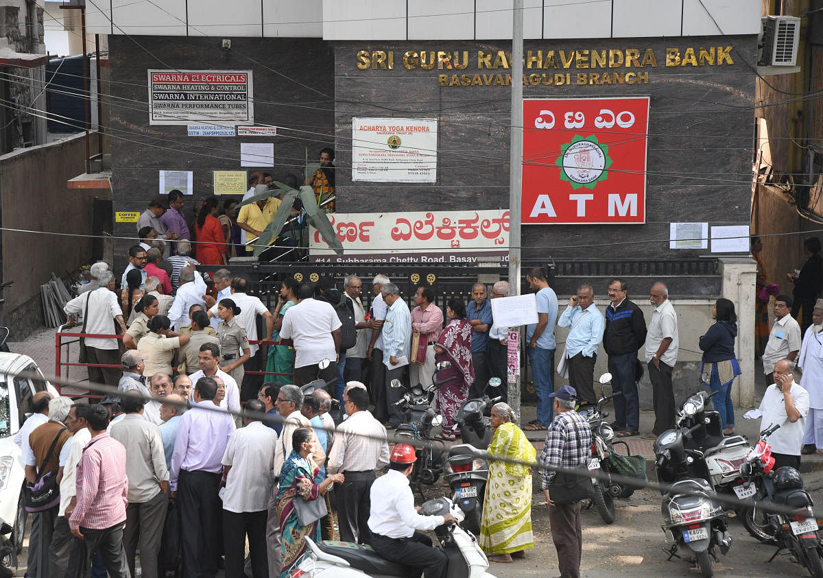 Depositors in front of the Sri Guru Raghavendra Co-operative Bank in Basavanagudi in Bengaluru on Monday. DH Photo/Srikanta Sharma R