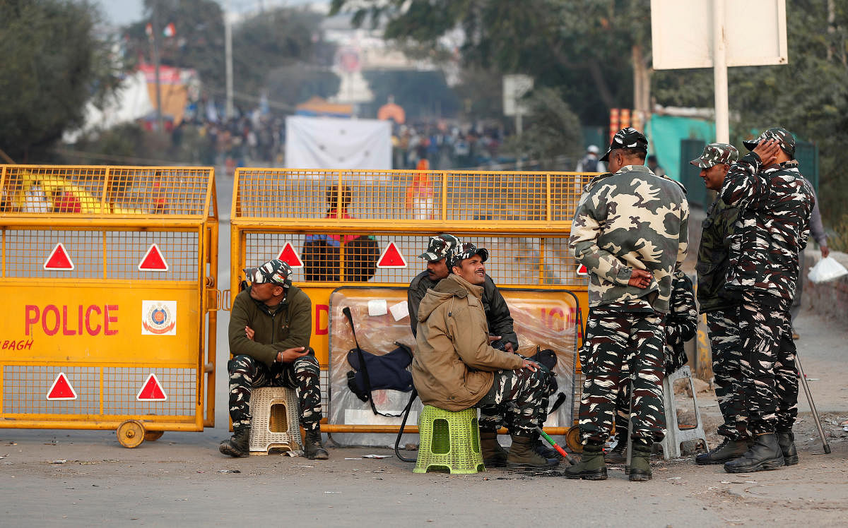 Central Reserve Police Force personnel are pictured next to a barricade at a protest site, in Shaheen Bagh, area of New Delhi. Reuters