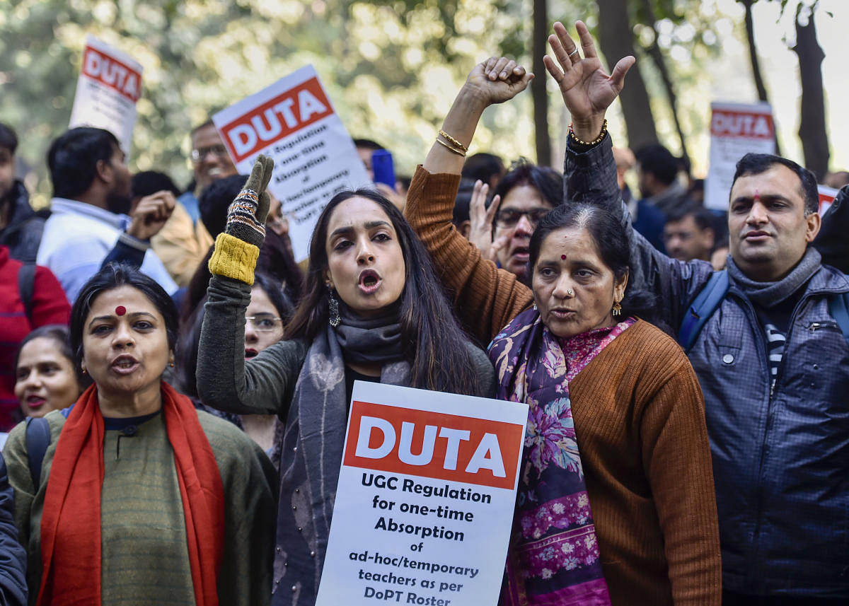 Delhi University Teachers' Association (DUTA) take part in a march demanding immediate implementation of the relief promised on Dec. 5 by MHRD/UGC. (PTI Photo)
