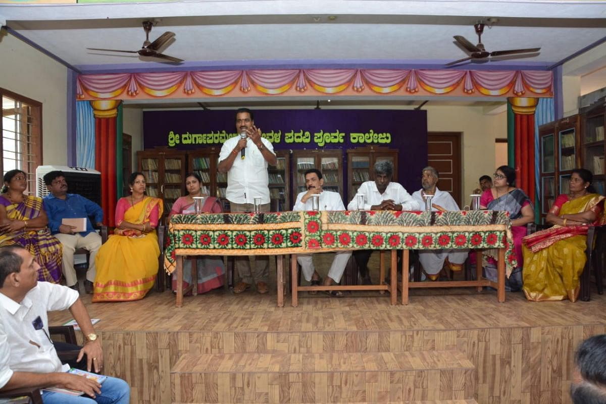 Moodbidri MLA Umanath Kotian speaks at a review meeting on the preparations for Brahmakalashotsava of Kateel Sri Durgaparameshwari Temple, held at Sri Durga Parameshwari Temple PU College in Kateel on Tuesday.   