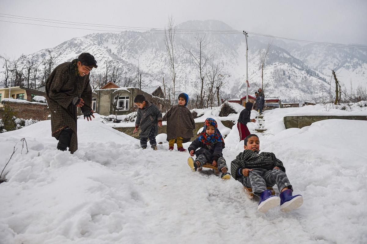 Children play with snow balls, after heavy snowfall on the outskirts of Srinagar, Tuesday, Jan. 14, 2020. (PTI Photo/S. Irfan)