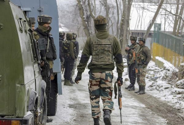 Army personnel take positions near a house where militants were hiding, during a cordon-and-search operation, at Gulshanpora in Tral area of South Kashmir, Sunday, Jan. 12, 2020. (PTI Photo)