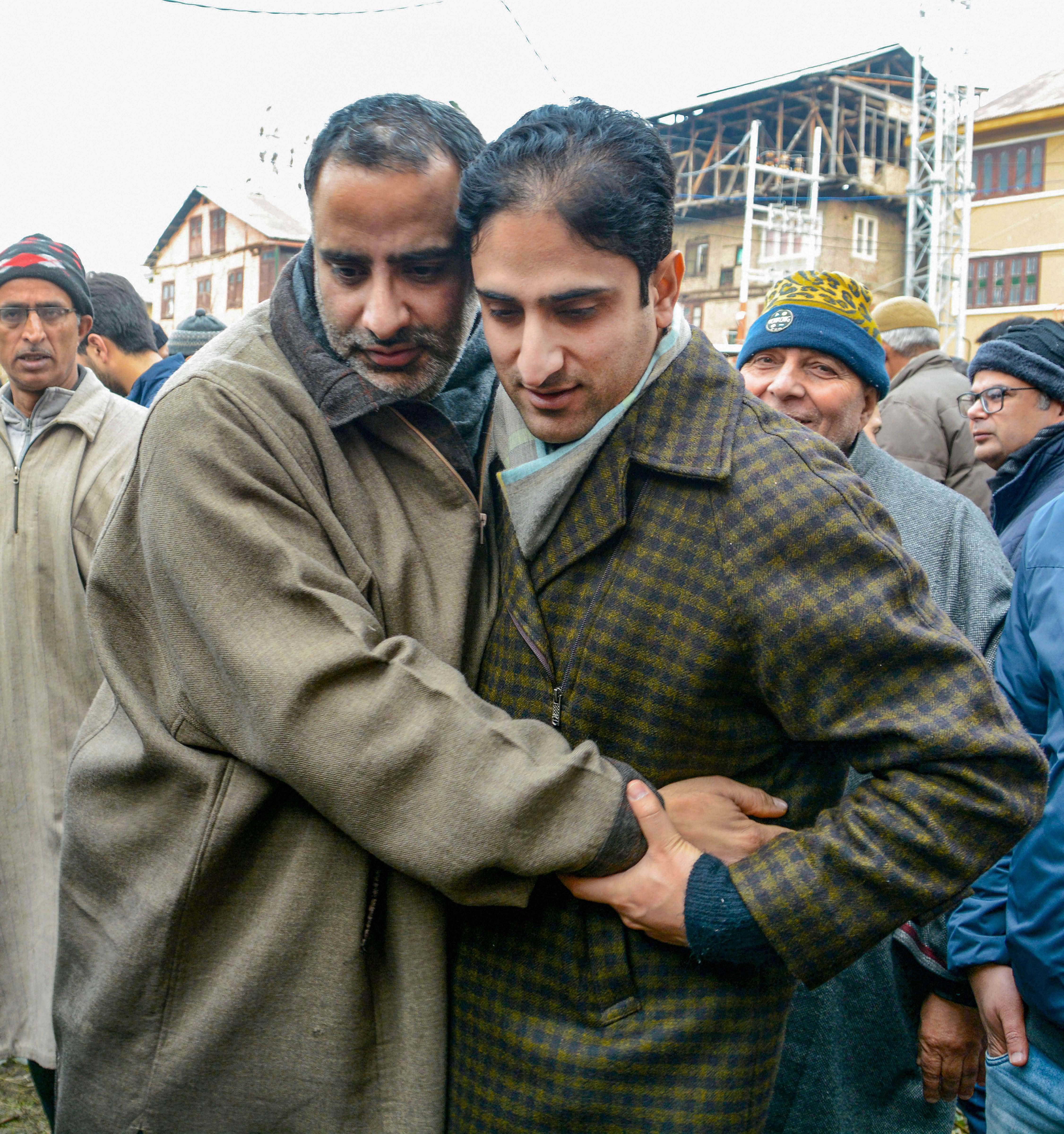 Srinagar Mayor Junaid Matto hugs National Conference Youth President Salman Sagar, who was under detention at a sub-jail since August 5 2019. (PTI Photo)