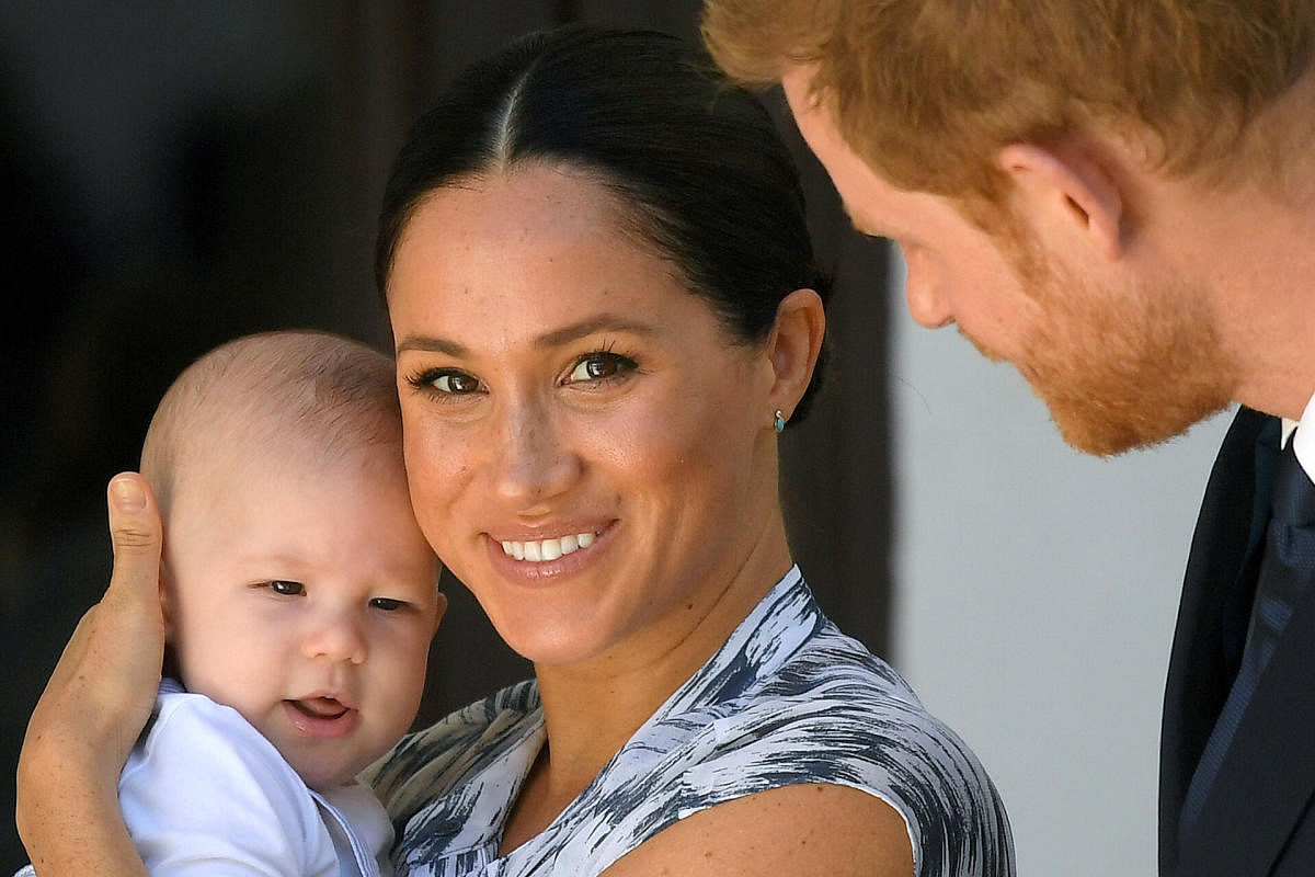 Britain's Prince Harry and his wife Meghan, Duchess of Sussex, holding their son Archie. (REUTERS photo)