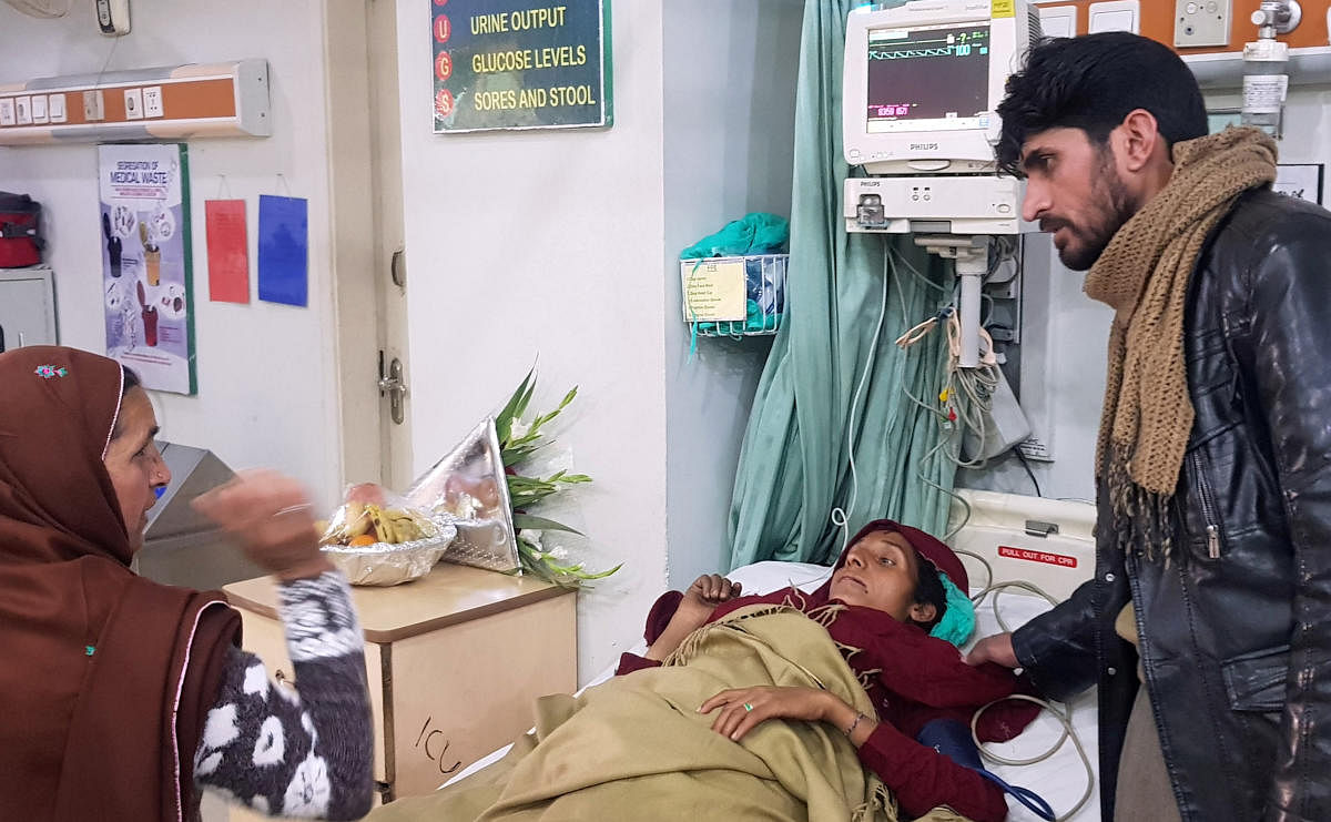 Shahnaz, who was rescued after a heavy snowfall and avalanches receives medical aid at a hospital in Muzaffarabad. (Reuters Photo)