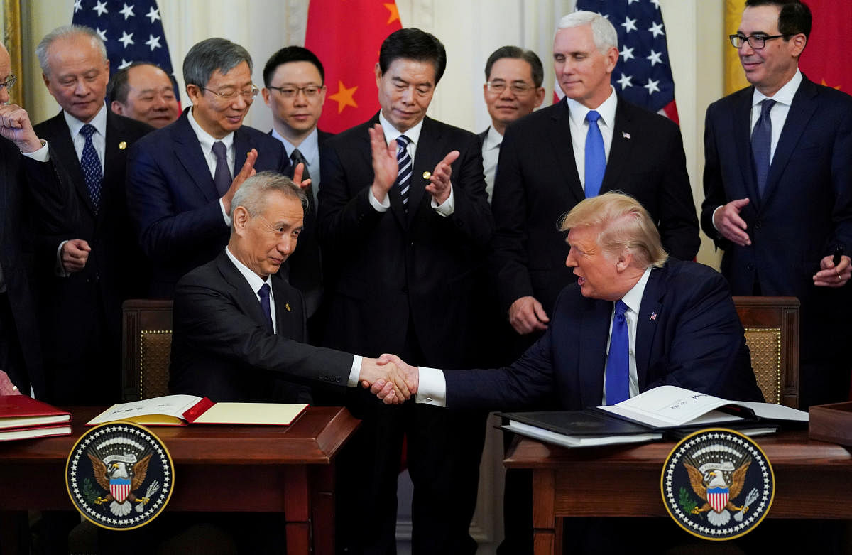 Chinese Vice Premier Liu He and U.S. President Donald Trump shake hands after signing "phase one" of the U.S.-China trade agreement at the White House in Washington. Credit: Reuters