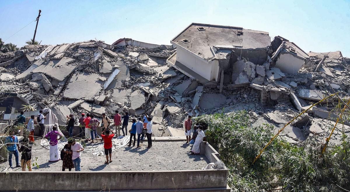 Debris are seen after a controlled implosion to demolish illegal apartments at Maradu in Kochi. (PTI Photo)