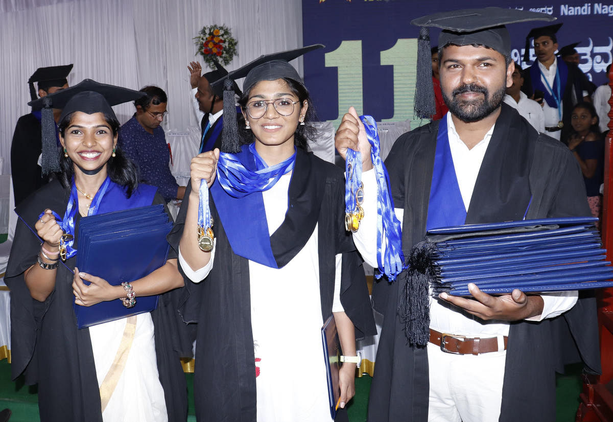 Shivani Mamane (5 gold medals), Shruthi Valson and Vishwas K M (10 medals apiece) proudly flaunt their medals at the Karnataka Veterinary, Animal and Fisheries University convocation in Bidar on Friday. DH PHOTO