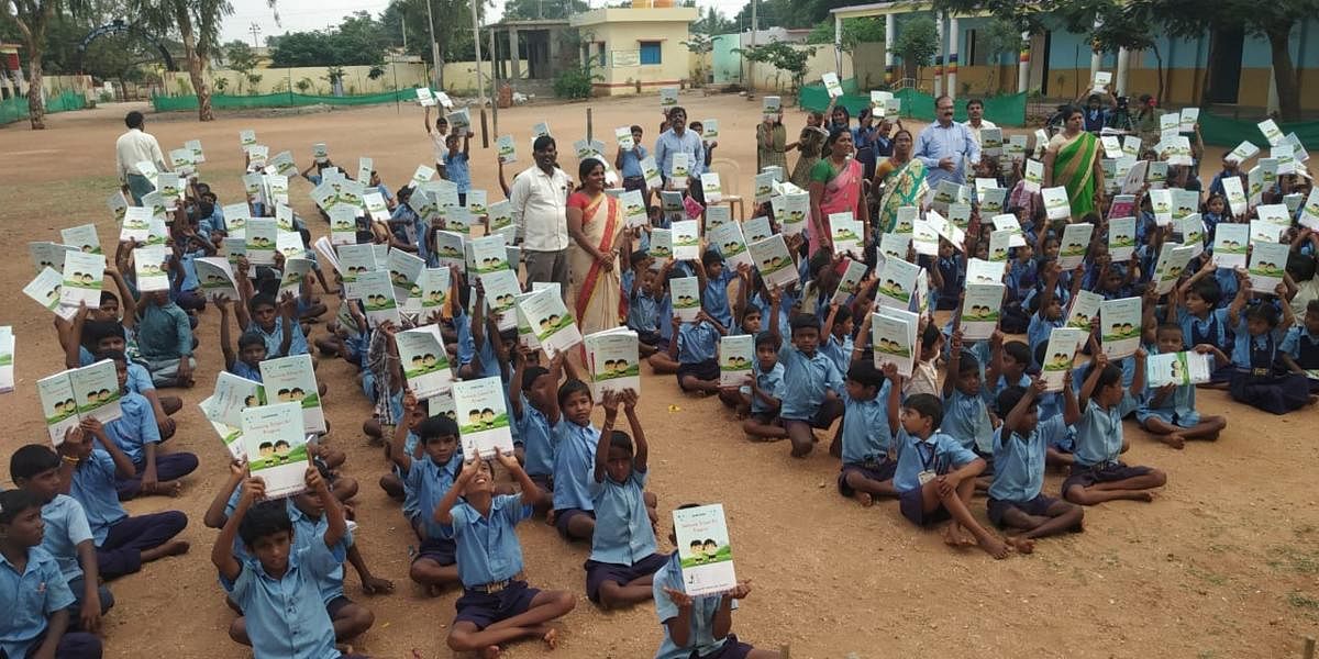 Children with the books provided through the initiative