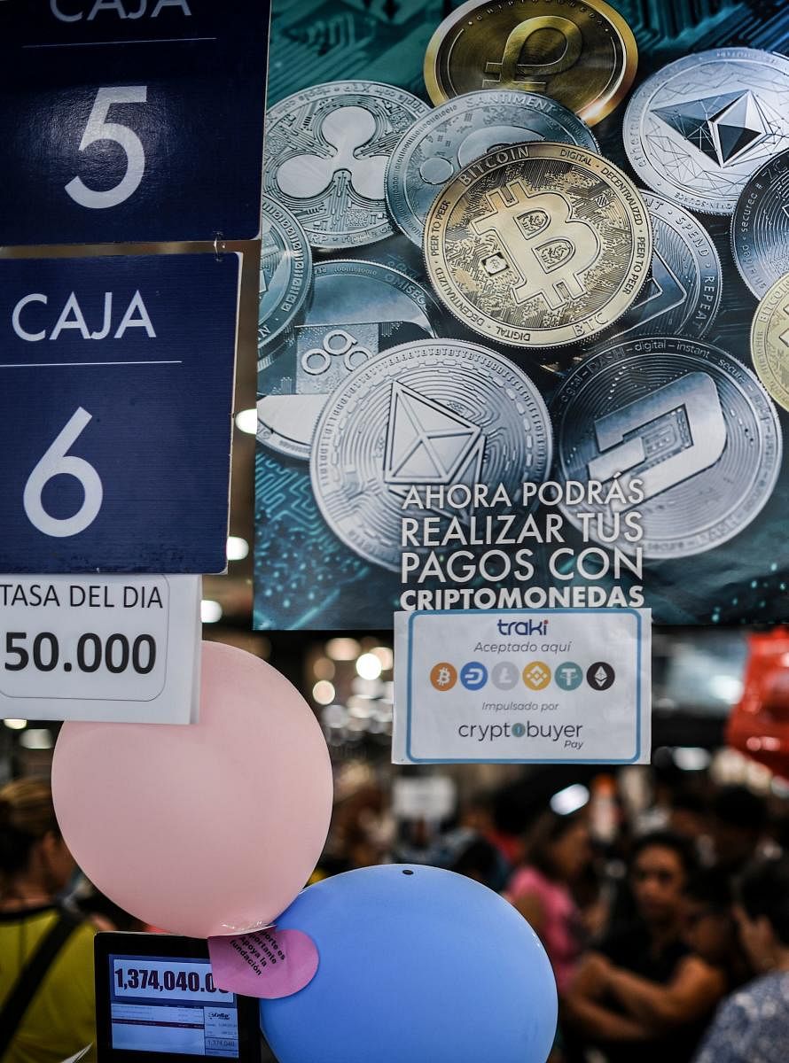 View of a poster reading "Now you will be able to make your payments with cryptocurrencies", referring to Venezuelan cryptocurrency Petro, at a store in Caracas. (AFP PHOTO)