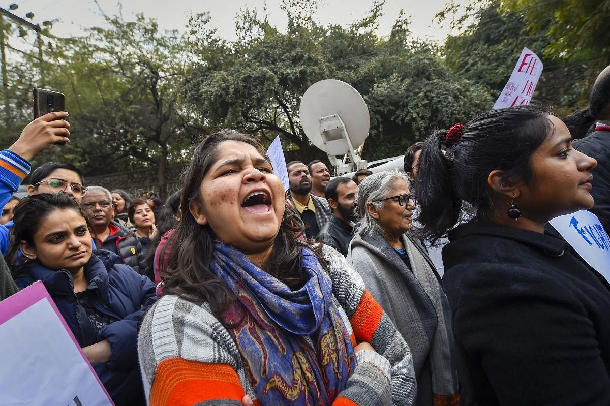 Members of Jawaharlal Nehru University Teachers' Association (JNUTA) and Jawaharlal Nehru University Students' Union (JNUSU) raise slogans during a protest. (PTI PHOTO)