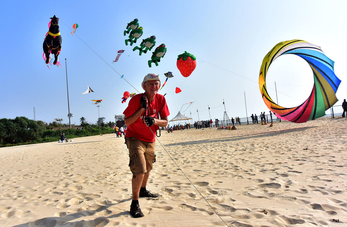Ron Spaulding from USA flies a kite during International Kite Festival held at Panambur beach in Mangaluru.