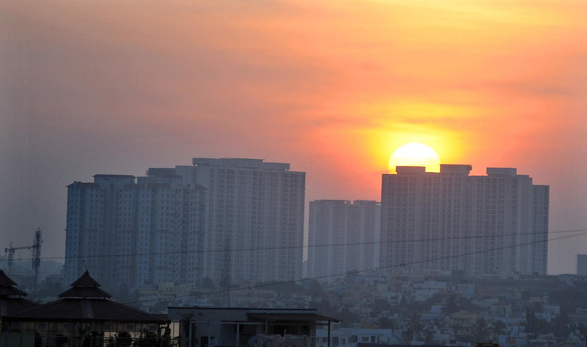 Sun sets behind apartment complex city scape in Bengaluru. (DH Photo/Pushkar V)