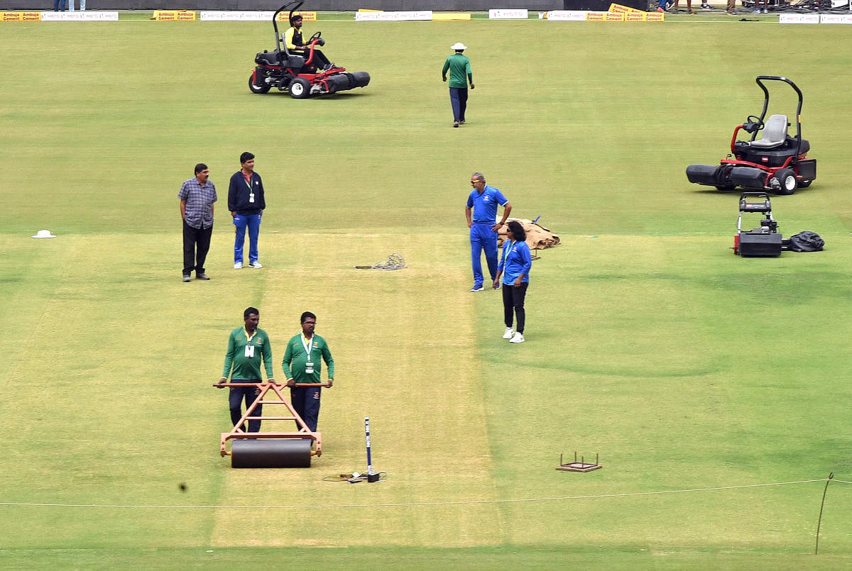 Groundsman at the Chinnaswamy Stadium get the pitch for the India versus Australia game ready on Saturday. DH PHOTO/ SRIKANTA SHARMA R