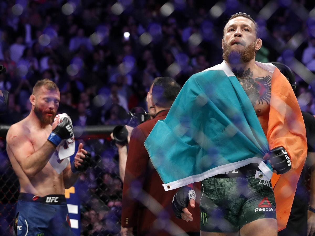 Conor McGregor celebrates his first round TKO victory against Donald Cerrone in a welterweight bout during UFC246 at T-Mobile Arena (Photo by AFP)