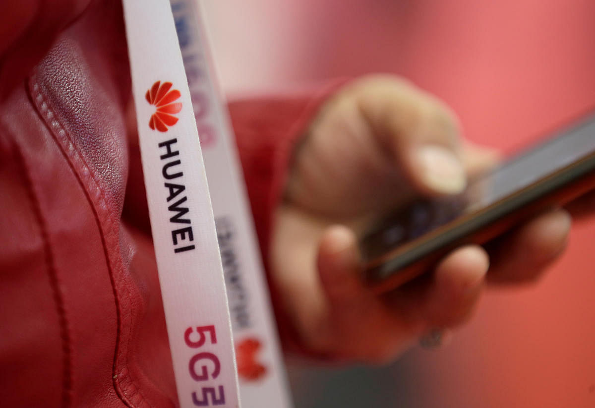 Huawei and a sign for 5G (Reuters Photo)
