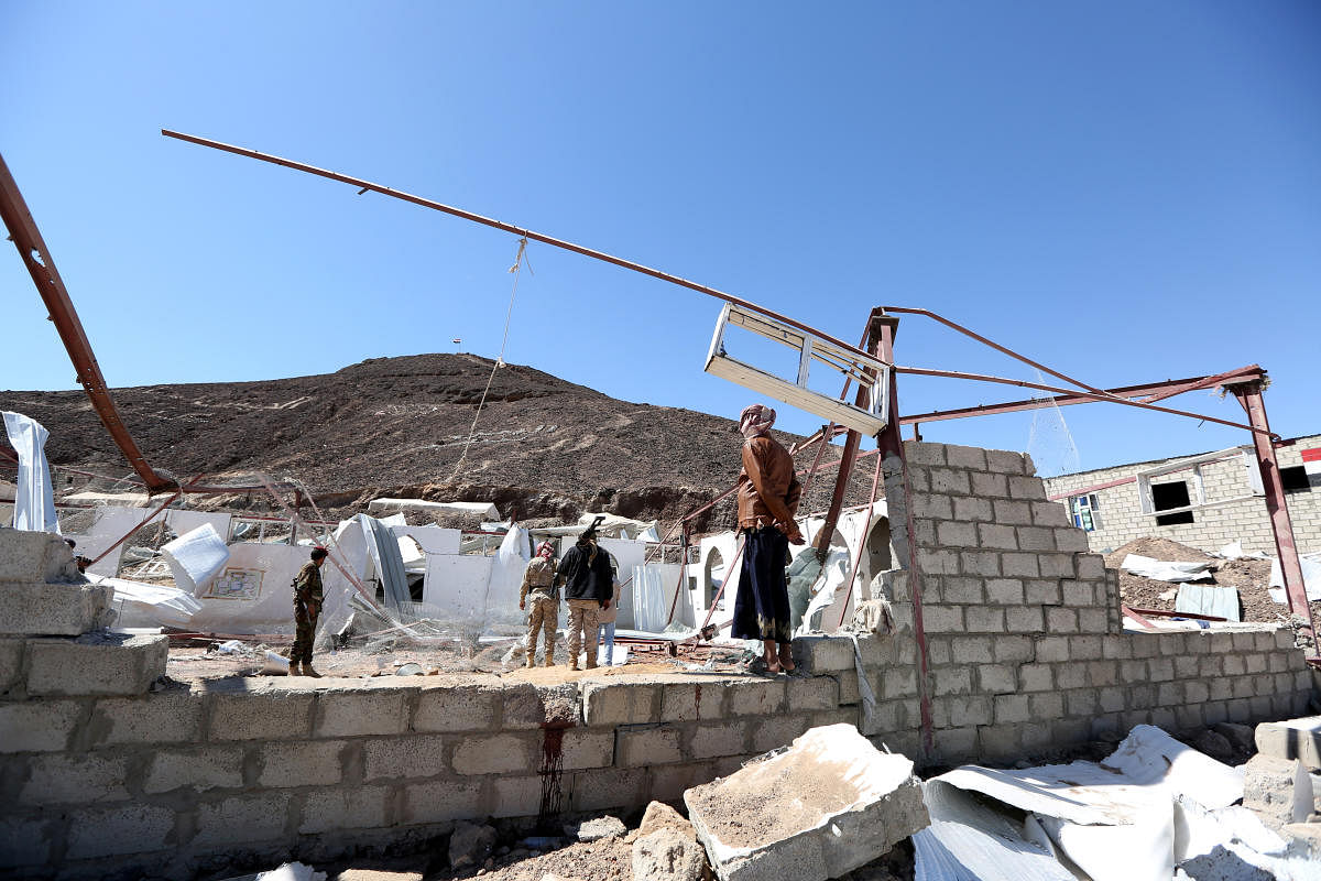 Government soldiers and other people inspect the site of a Houthi missile attack on a military camp’s mosque in Marib. (Reuters Photo)