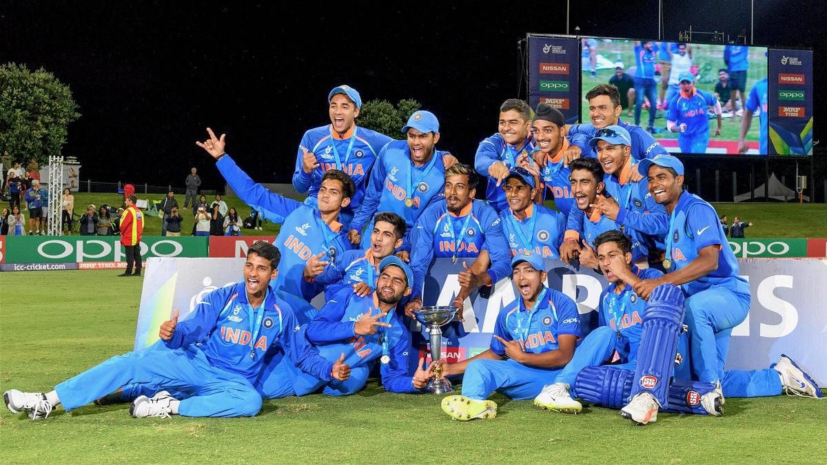 Mount Maunganui: Indian team players pose for photographs with the trophy as they jubilate after winning the ICC Under-19 Cricket World Cup finals in Mount Maunganui. (PTI PHOTO)