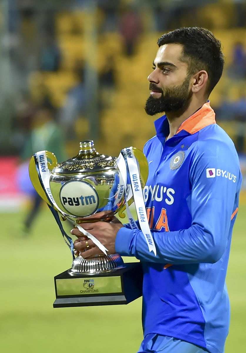 India's Skipper Virat Kohli with the trophy after India won the third and final ODI cricket match against Australia at Chinnaswamy stadium in Bengaluru. (PTI PHOTO)